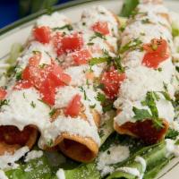 Cheese Tropical Flautas · Lettuce tomatoes sour cream and cotija cheese.