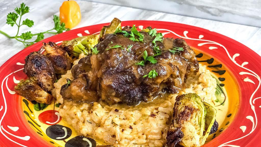 Jamaican Oxtail Plate · 6-hour braised oxtail in a stew of Jamaican spices, vegetables and the spirits of the ancestors until fall off the bone tender. Served with coconut rice and peas