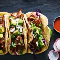 The Pork Taco · Delicious fusion taco made with seasoned grilled pork, chopped onions, cilantro, cheese, and...