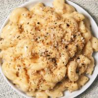 Mac And Cheese De Mentequilla · A large portion of macaroni prepared with freshly made cheese sauce, brown butter, and bread...