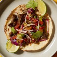 Barbacoa Taco · Tender slow cooked beef served with onions, cilantro and your choice of salsa.