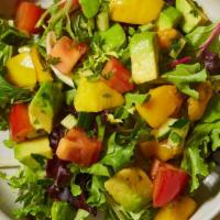 Mango Avocado Salad · Spring mix salad with mango, avocado, cucumbers, tomatoes and citrus ponzu.