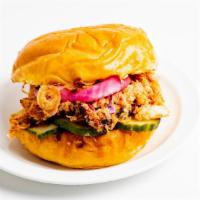 Pulled Chicken Sandwich · Served on a brioche bun with pickles, cabbage, pickled onions, crispy onions, a side of slaw...