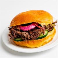 18 Hour Beef Sandwich · Served on a brioche bun with pickles and accompanied by one side with your choice of sauce a...