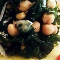 Warm Chickpea Spinach Salad · Warm chickpea and spinach salad with manchego cheese, lemon olive oil, and tomatoes.