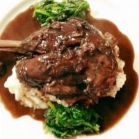 Braised Lamb Shank · Braised in red wine, vegetables, Mexican spices, mashed potatoes, spinach.
