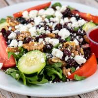 Melissa Salad · Dried cranberries, walnuts and goat cheese over arugula salad with a lite raspberry vinegare...