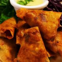 Chicken Curry Puffs · Grounded chicken, potato, Curry powder, scallion, cilantro, Wrapped with egg roll skin, serv...