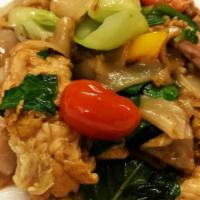 Pad Kee Mow · Flat rice noodle sautéed with egg, chili, broccoli, seasonal Asian green, tomatoes, and swee...