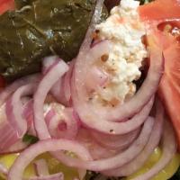 Greek Salad · Feta, onion, grape leaves, olive, peppers, tomato, cucumber, lettuce topped with Greek dress...