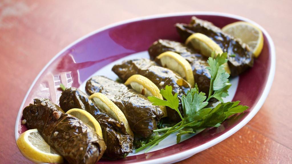 Stuffed Grape Leaves (V) (6 Pieces) · Grape leaves, stuffed with rice, onion, tomato, parsley and spices.