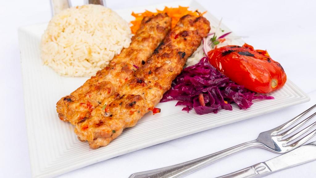 Chicken Adana · Chopped chicken flavored with fresh bell peppers, gently spiced paprika and char-grilled on a skewer. Served with rice and vegetables.