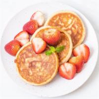 Strawberry Pancakes · Fluffy strawberry buttermilk pancake stack.