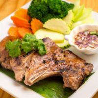 Grandma'S Pork Chop · Seared pork chops, toasted rice, chilli sauce, and steamed vegetables.