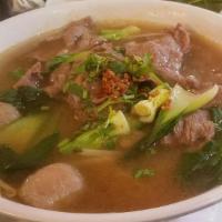 Pho Beef Soup · Sliced beef with thin rice noodle, meat balls, bok choy, bean sprout, and basil.