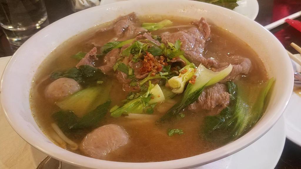 Pho Beef Soup · Sliced beef with thin rice noodle, meat balls, bok choy, bean sprout, and basil.