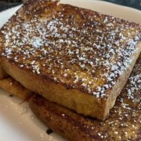 French Toast · Challah bread dipped in rich egg batter. served with syrup.
