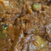 Baingan Bharta · Mashed eggplant cooked in savory spices and green peas.