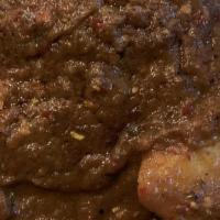 Lamb Vindaloo · Very hot. Spiced lamb cooked in a tangy sharp onion and tomato gravy.