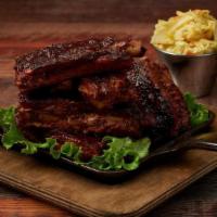 Trash Ribs · Memphis Ribs Simmered in Mild BBQ Sauce & Served with Mustard Cole Slaw