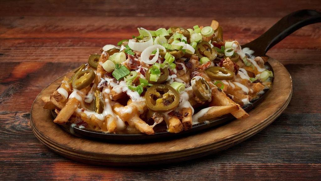 Trainwreck Fries · Melted Cheddar, Jack Cheese, Smoked Bacon, Scallions, & Jalapenos with Ranch Dressing