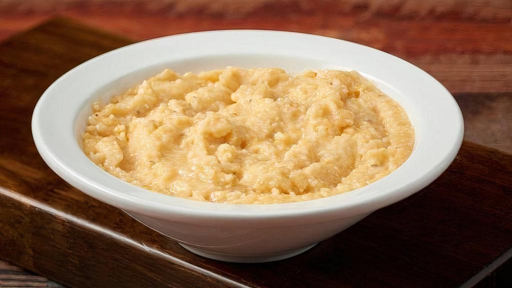 Cheddar Cheese Grits · White Corn Grits with Cheddar & Parmesan Cheeses Spiked with Hot Sauce for a Kick