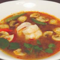 Tom Yum Shrimp · Spicy and sour soup, seasoned with exotic Thai herbs, mushrooms, lemongrass, and kaffir lime...