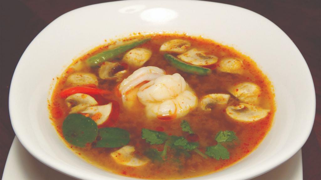 Tom Yum Shrimp · Spicy and sour soup, seasoned with exotic Thai herbs, mushrooms, lemongrass, and kaffir lime leaves.