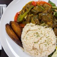 Curry Goat · Medium size serving of curry goat with white rice or rice and peas, steamed vegetables and p...