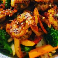 Jerk Shrimp · Jerk shrimp grilled and cooked pleasing to the taste buds. Served with rice peas cabbage pla...