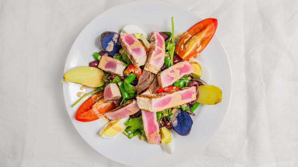 Salad Nicoise · Seared tuna, black olives, green beans, hard boiled egg, mixed peppers, fingerling potato, tomato & anchovy.