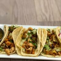 Pollo Tacos · Tacos served with soft onion and cilantro.