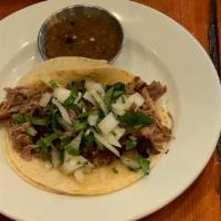 Carnitas Tacos · Tacos served with soft onion and cilantro. Served with pico de gallo, lettuce, and cheese on...