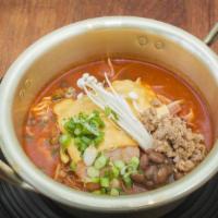 Budae Jjigae / 부 대찌게 · Army stew. Hot pot dish loaded with kimchi, spam, sausages, ramen noodles.