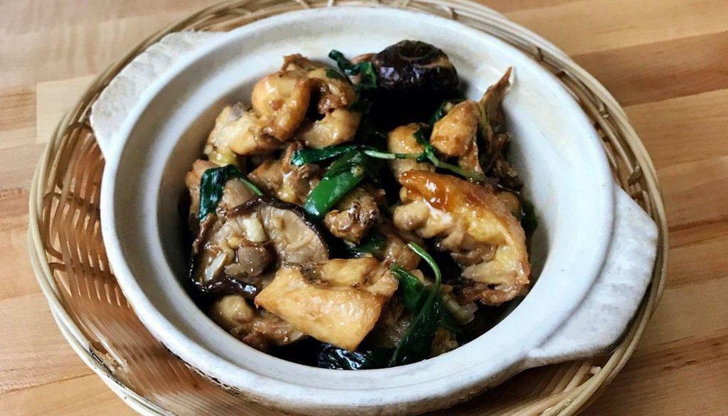 Basil Chicken Mushroom Claypot Stew 香菇滑鸡煲 · Famous slow-braised bone-in chicken in dark soy sauce with basil and mushroom. Served with rice.