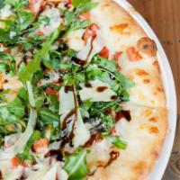 Romana  · Chopped tomatoes, fresh mozzarella, arugula and shaved parmigiano