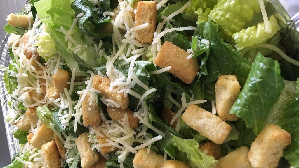 Chicken Caesar Salad · Chopped romaine lettuce, sliced chicken breast, parmesan cheese, and Caesar dressing. Tossed and topped with croutons.