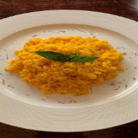 Risotto Allo Zafferano · risotto with browned onion shaded with , saffron sauce and parmesan.