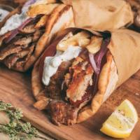 Greek Gyro Platter (-) · Beef or chicken on a pita bread with lettuce, tomatoes, onions, tzatziki sauce and fries.