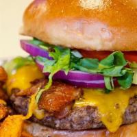 Bacon Cheddar Burger · 1/2 lb burger topped with cheddar cheese, Applewood smoked bacon, lettuce, tomato & onion on...