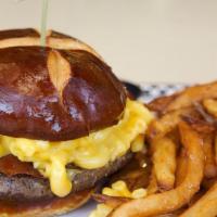 Mac N Cheese Burger · 1/2 lb burger topped with mac n cheese & Applewood smoked bacon on a pretzel bun served with...