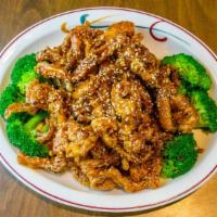 Sesame Chicken · Crispy chicken strip, sweet, and tangy sauce coated with sesame seeds. Served with white ric...
