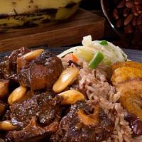 Braised Oxtail · Served with steamed veg and plantain.