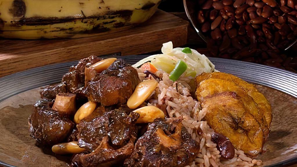 Braised Oxtail · Tender braised oxtails a real Caribbean favorite. Served with rice and peas or white rice, and steamed vegetables.