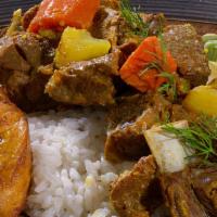 Curried Goat · Served with steamed veg and plantain.