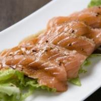 Citrus Salmon Carparccio · Torched salmon dressed with garlic and black pepper, served with yuzu wasabi sauce.