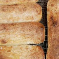 Cheesy Garlic Bread · ~ loaf of house made garlic bread w/melted fresh mozzarella