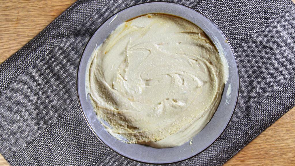 Homemade Hummus · Vegan. Puréed chickpeas, tahini, garlic, and lemon juice, served with pita bread.
