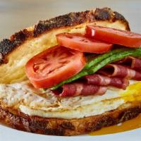 Breakfast Sandwich · Over-medium eggs, avocado, tomato and turkey bacon on toasted balthazar artisan sourdough.