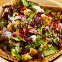 Falafel Village Salad · Chopped organic mesclun, house made falafel, tomatoes, cucumbers, onions and red cabbage wit...